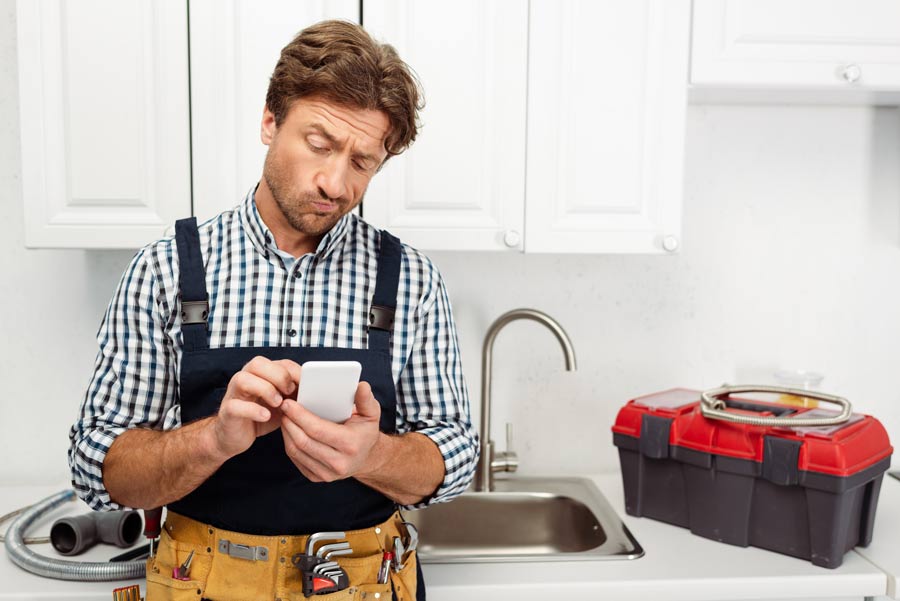 plumber-using-crm-system-on-his-smart-phone